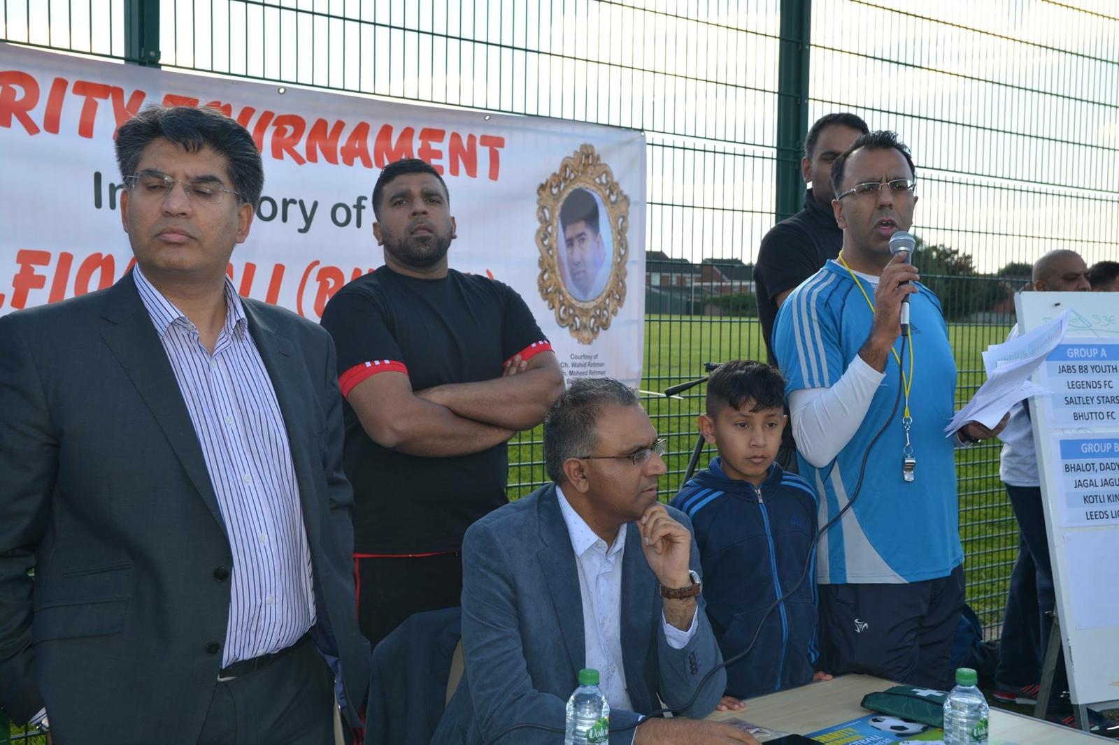 Mr Ali speaking at a charity football tournament