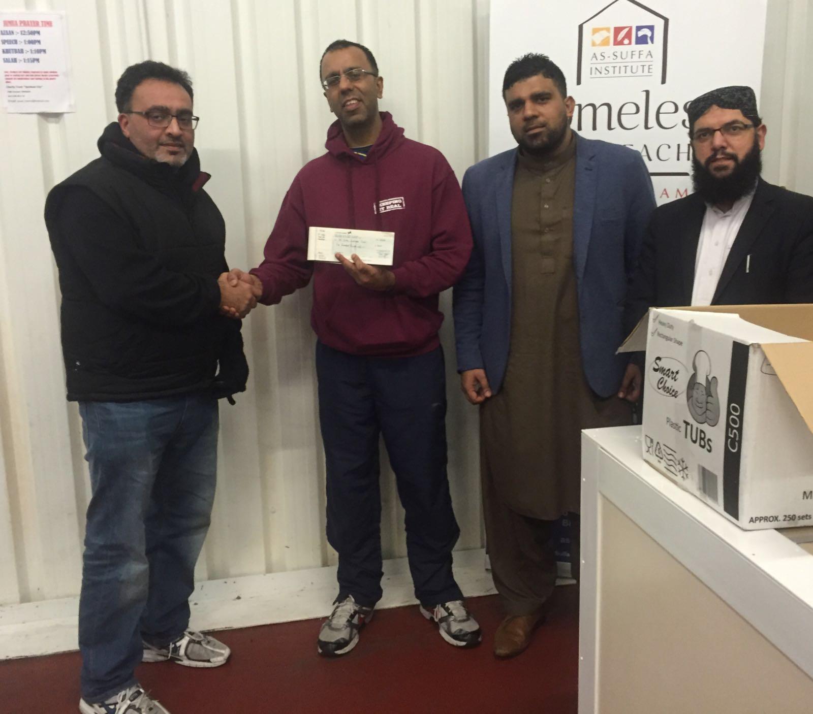 Mr Ali presenting donation cheque to As-Suffa Institute