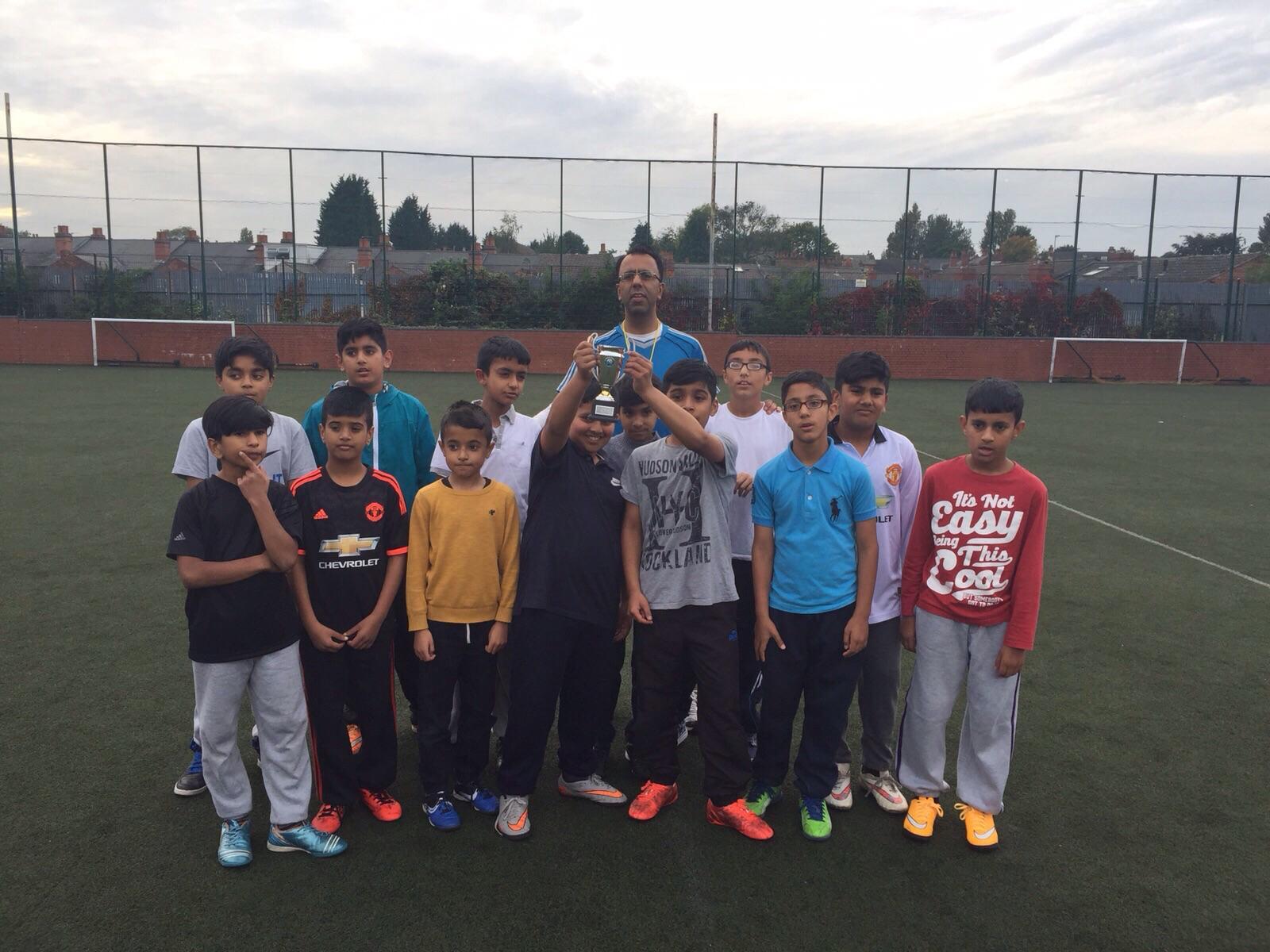 Mr Ali with JABS B8 youth team and trophy